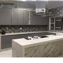 Fitted kitchen with marble waterfall island